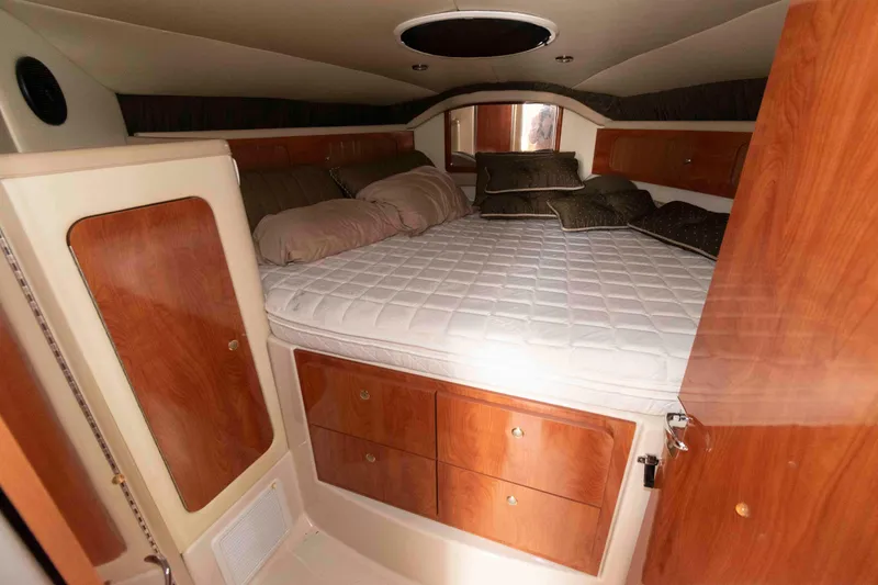 Slide: The Image of Interior cabin of 2007 Larson Cabrio 370 with cozy bed and wooden storage. - 13