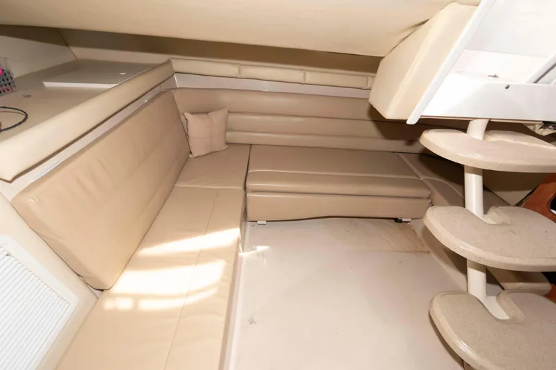 Slide: The Image of Interior of 2007 Larson Cabrio 370 boat with beige seating and curved steps. - 17