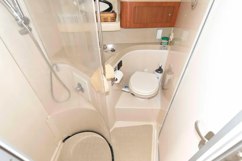 Slide: The Image of 2007 Larson Cabrio 370 bathroom with shower, toilet, and storage cabinet. - 18