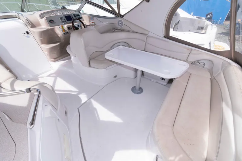Slide: The Image of 2007 Larson Cabrio 370 boat interior with seating and table in cockpit area. - 4