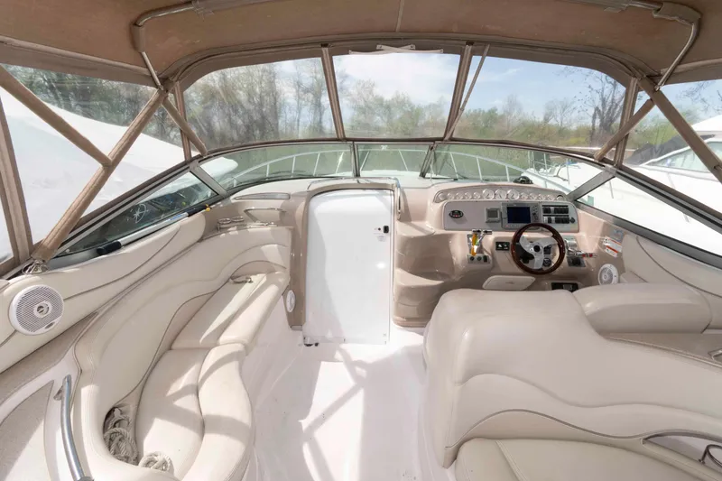 Slide: The Image of Interior of a 2007 Larson Cabrio 370 boat with beige seating and modern dashboard. - 5