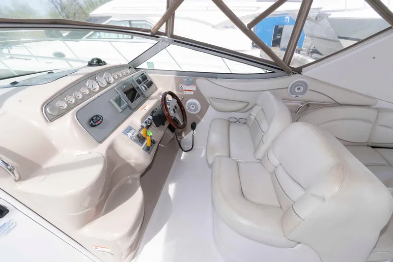 Slide: The Image of 2007 Larson Cabrio 370 boat interior with steering wheel and dashboard controls. - 6