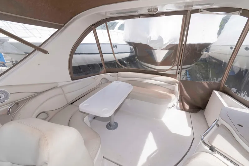 Slide: The Image of 2007 Larson Cabrio 370 boat interior with beige seating and table. - 8