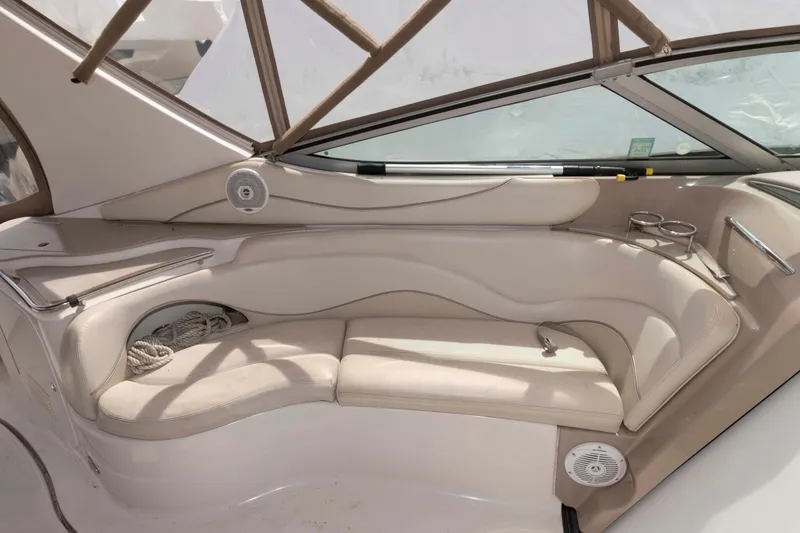 Slide: The Image of 2007 Larson Cabrio 370 boat interior with beige seating and cup holders. - 9
