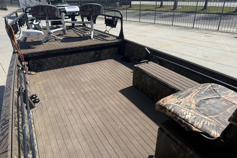 Slide: The Image of 2022 Pro-Drive SBX 2060x boat interior with camo seats and spacious deck. - 10