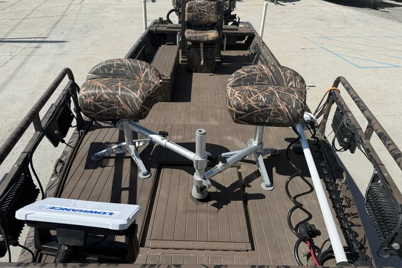 Slide: The Image of 2022 Pro-Drive SBX 2060x boat interior with camo seats and fishing equipment. - 11