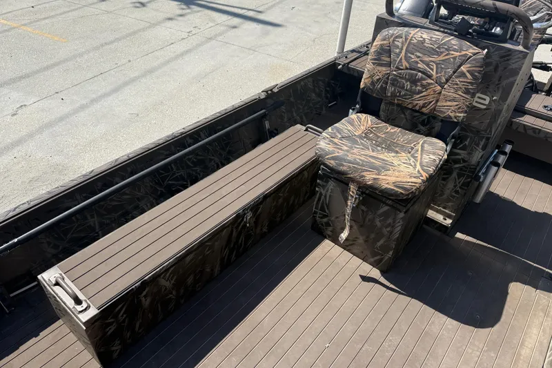 Slide: The Image of 2022 Pro-Drive SBX 2060x boat interior with camo seating and storage. - 12