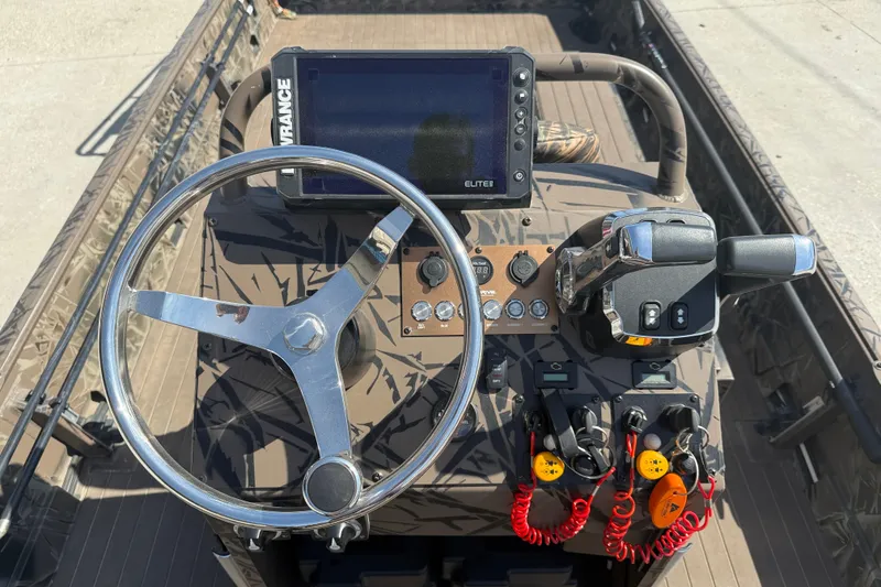 Slide: The Image of 2022 Pro-Drive SBX 2060x boat dashboard with steering wheel and control panel. - 14