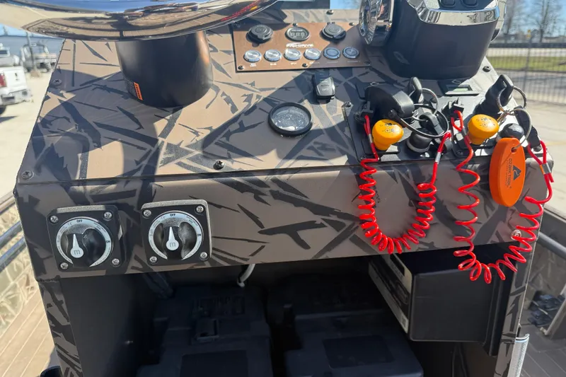 Slide: The Image of Control panel of 2022 Pro-Drive SBX 2060x boat with safety lanyards and switches. - 15