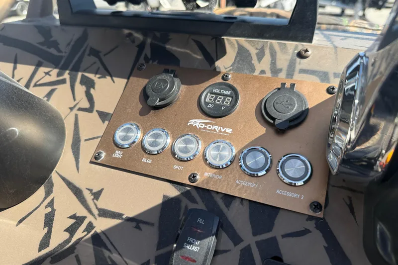 Slide: The Image of Control panel of 2022 Pro-Drive SBX 2060x boat with switches and voltage display. - 16