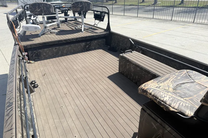 Slide: The Image of 2022 Pro-Drive SBX 2060x boat interior with camo seats and spacious deck. - 8