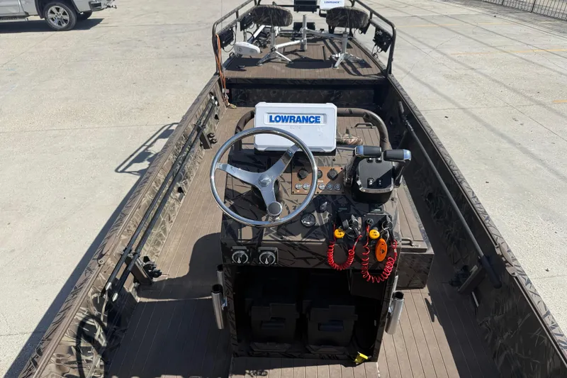 Slide: The Image of 2022 Pro-Drive SBX 2060x boat interior with steering wheel and Lowrance navigation system. - 9