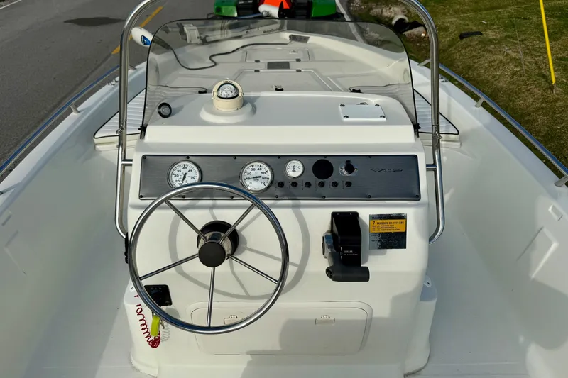 Slide: The Image of 2002 Bay Stealth 2030 boat dashboard with steering wheel and gauges. - 10