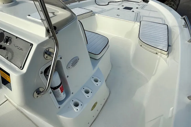 Slide: The Image of Interior of a 2002 Bay Stealth 2030 boat, featuring seating and control panel. - 13