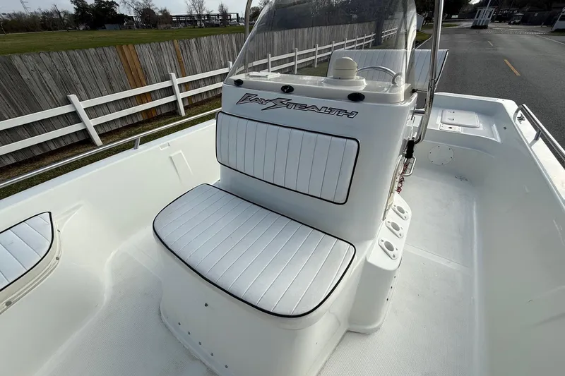 Slide: The Image of 2002 Bay Stealth 2030 boat interior with white seating and console. - 16