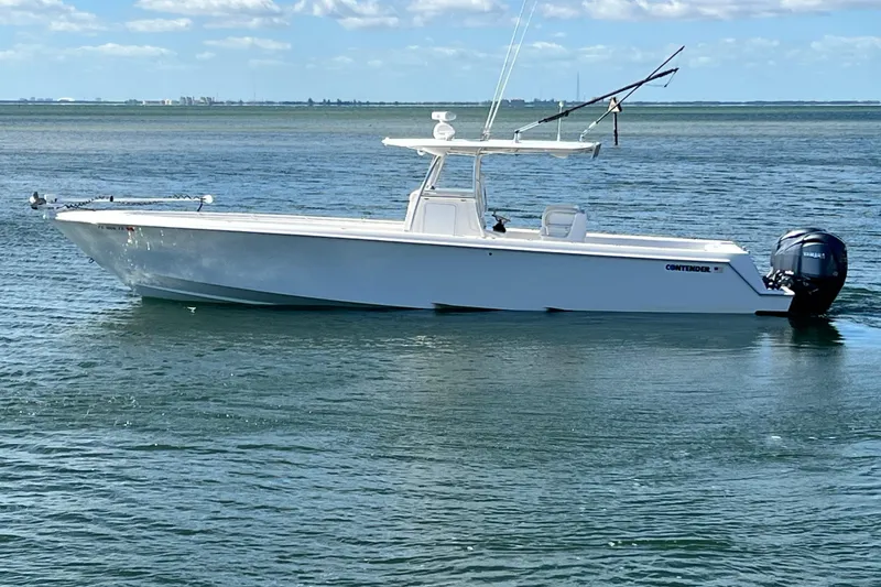 The Image of 2023 Contender 39 ST boat on calm water under a clear sky. - 0