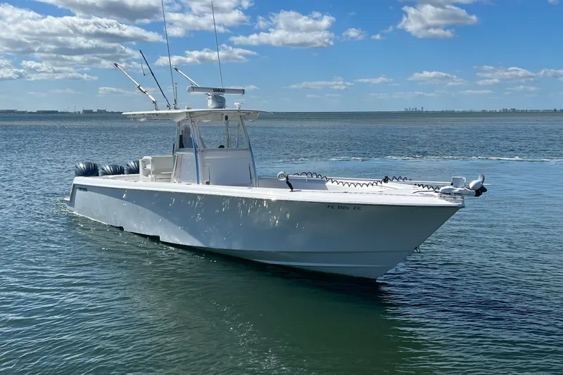 Slide: The Image of 2023 Contender 39 ST boat on calm water under a blue sky. - 1