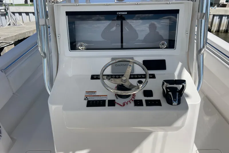 Slide: The Image of 2023 Contender 39 ST boat helm with Garmin navigation and steering wheel. - 13