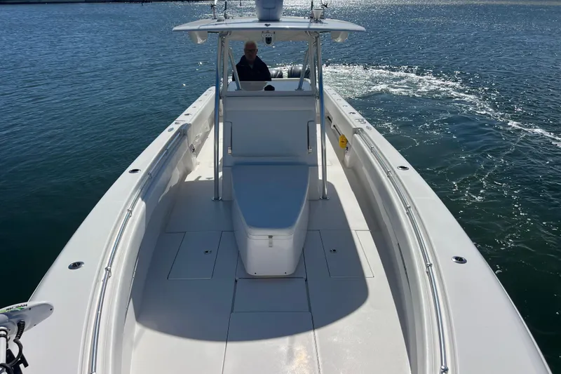 Slide: The Image of 2023 Contender 39 ST boat cruising on open water, showcasing sleek design and spacious deck. - 18
