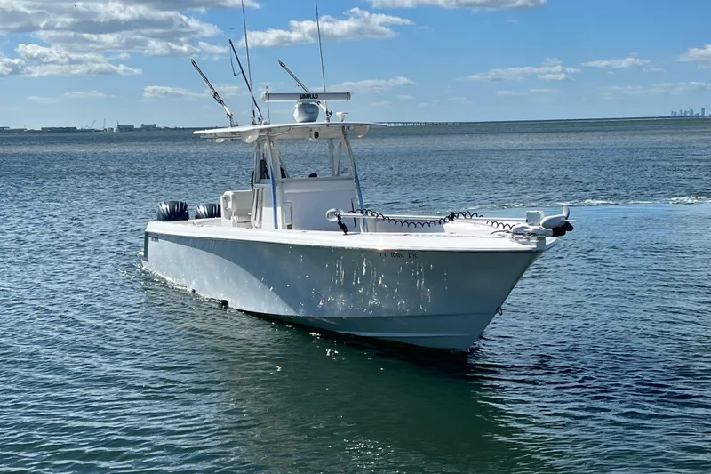 Slide: The Image of 2023 Contender 39 ST boat on calm water under blue sky. - 24