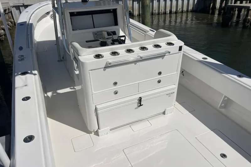 Slide: The Image of 2023 Contender 39 ST boat interior with helm station and storage compartments. - 31
