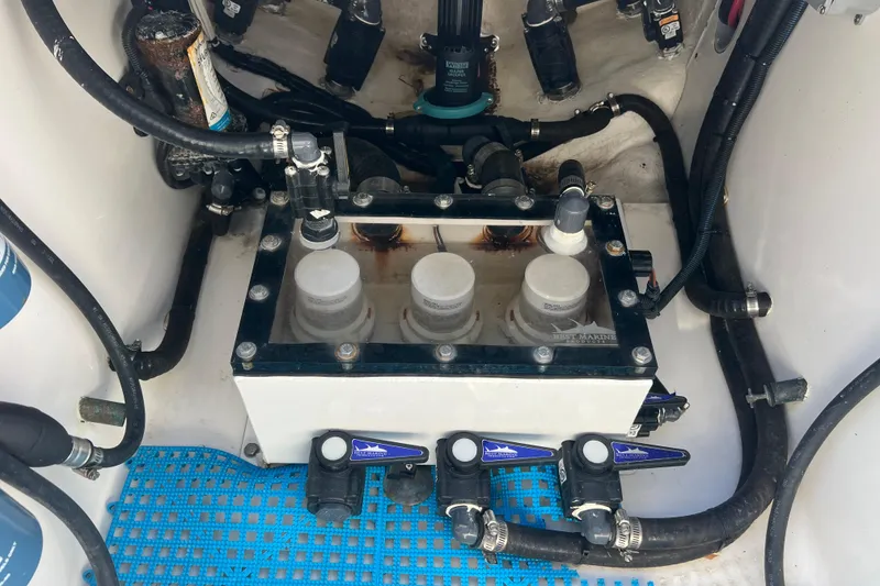 Slide: The Image of Engine compartment of 2023 Contender 39 ST boat with visible filters and hoses. - 33