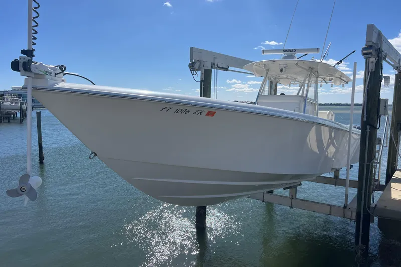 Slide: The Image of Contender 39 ST 2023 boat on lift by the water. - 37