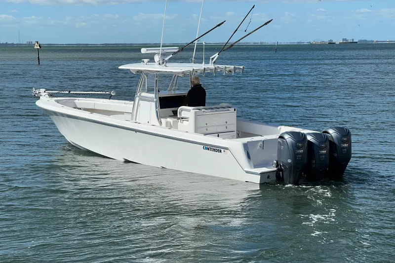 Slide: The Image of 2023 Contender 39 ST boat with triple outboard engines on open water. - 4