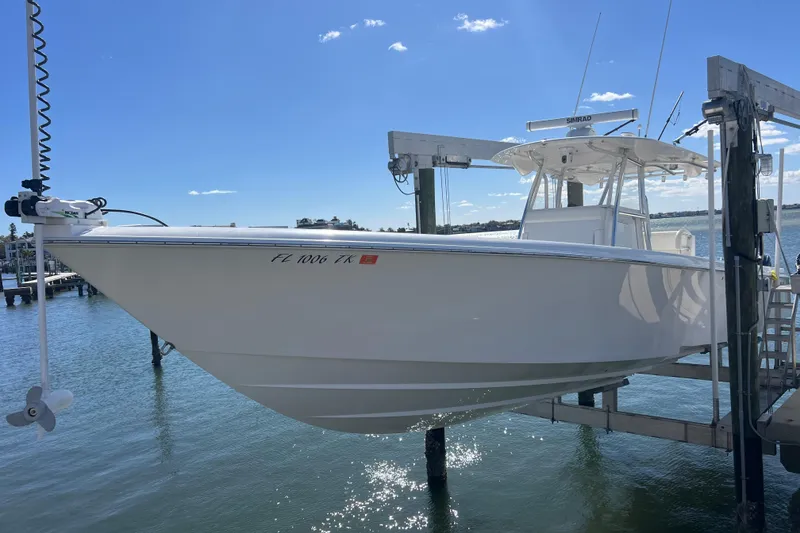 Slide: The Image of 2023 Contender 39 ST boat on lift, sunny day, clear blue sky. - 6