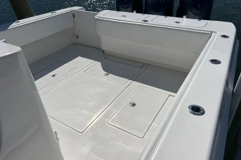Slide: The Image of 2023 Contender 39 ST boat deck with storage compartments and rod holders. - 8