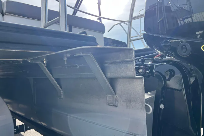 Slide: The Image of 2023 Harris Cruiser 210 SL boat, close-up of rear structure and motor components. - 16