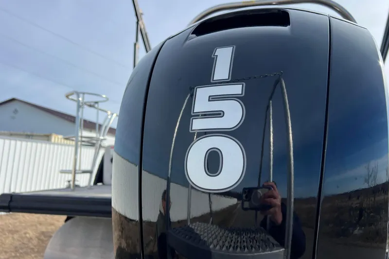 Slide: The Image of Close-up of a 2023 Harris Cruiser 210 SL boat engine with "150" decal. - 18