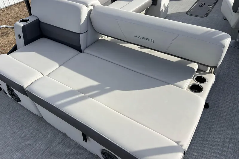 Slide: The Image of 2023 Harris Cruiser 210 SL boat seating with cup holders, featuring sleek gray upholstery. - 20