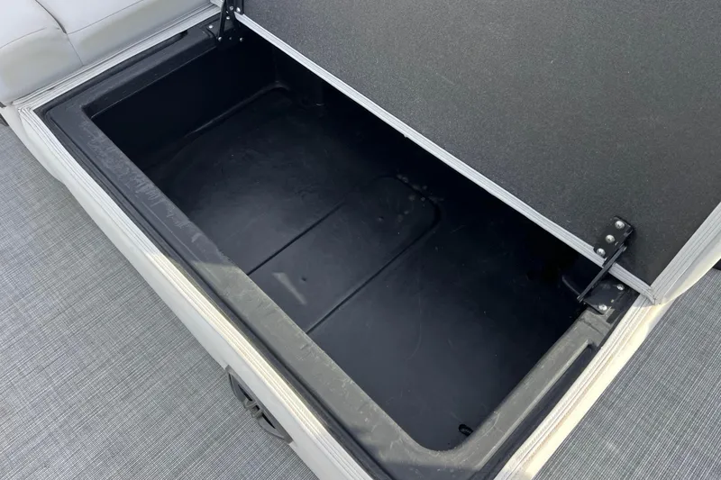 Slide: The Image of Open storage compartment on 2023 Harris Cruiser 210 SL boat. - 23