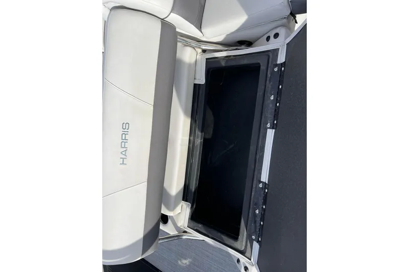 Slide: The Image of 2023 Harris Cruiser 210 SL boat seat with storage compartment open. - 27
