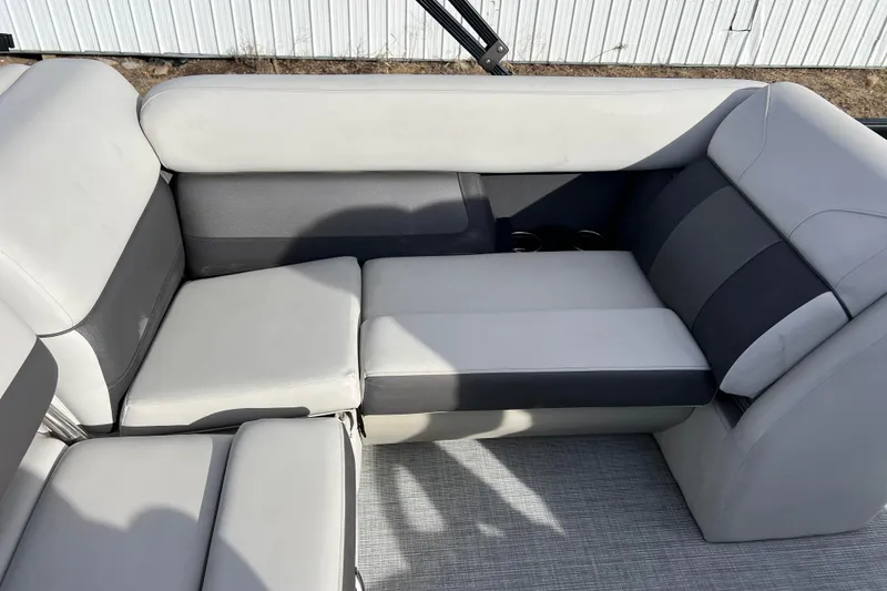 Slide: The Image of 2023 Harris Cruiser 210 SL boat interior with gray and white cushioned seating. - 28