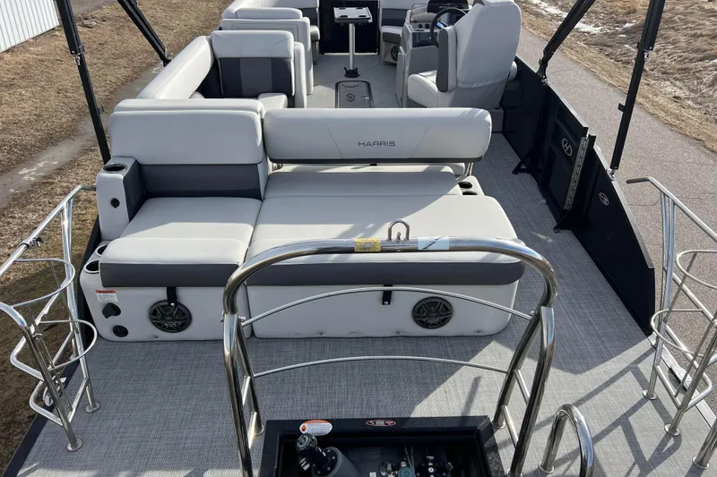 Slide: The Image of 2023 Harris Cruiser 210 SL pontoon boat with spacious seating and modern design. - 3