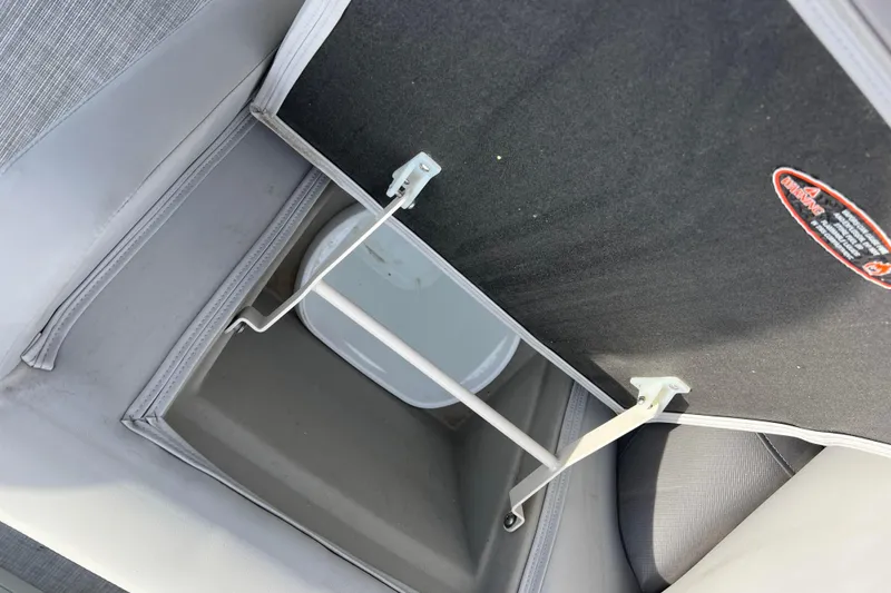 Slide: The Image of Storage compartment in 2023 Harris Cruiser 210 SL boat with open lid and bucket inside. - 30