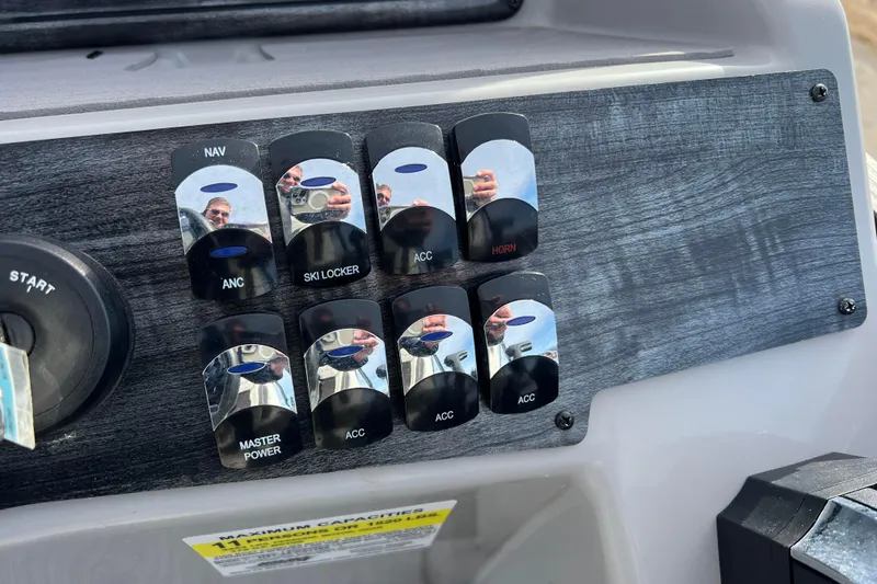 Slide: The Image of Control panel of 2023 Harris Cruiser 210 SL boat with labeled switches. - 34