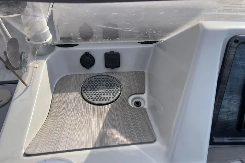 Slide: The Image of 2023 Harris Cruiser 210 SL boat console with charging ports and speaker. - 37