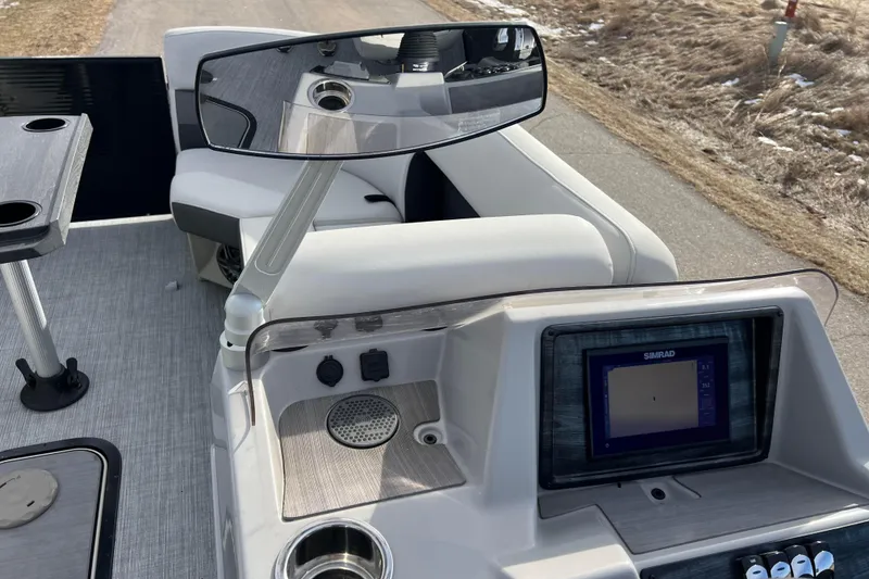 Slide: The Image of 2023 Harris Cruiser 210 SL boat dashboard with Simrad display and cup holders. - 39
