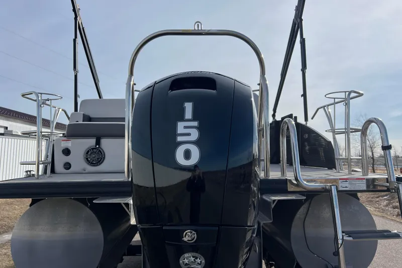 Slide: The Image of 2023 Harris Cruiser 210 SL pontoon boat with 150 horsepower engine, rear view. - 4