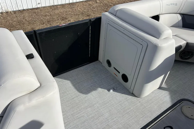 Slide: The Image of 2023 Harris Cruiser 210 SL boat interior with light gray seating and flooring. - 40