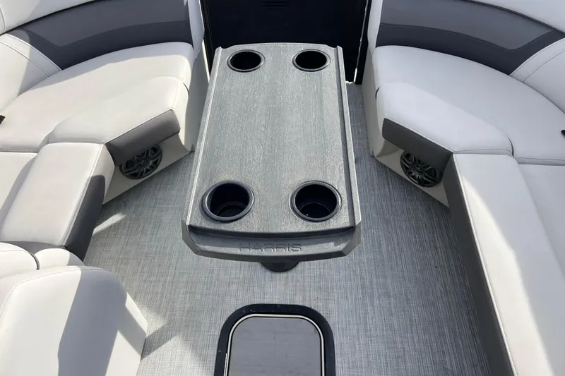 Slide: The Image of 2023 Harris Cruiser 210 SL interior with seating and cup holders. - 42