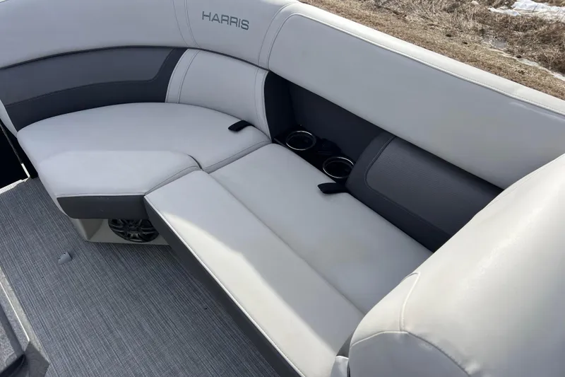 Slide: The Image of 2023 Harris Cruiser 210 SL boat interior with gray seating and cup holders. - 44