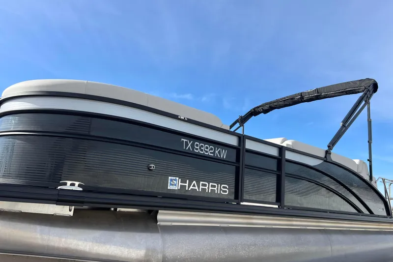 Slide: The Image of 2023 Harris Cruiser 210 SL pontoon boat under clear blue sky. - 5