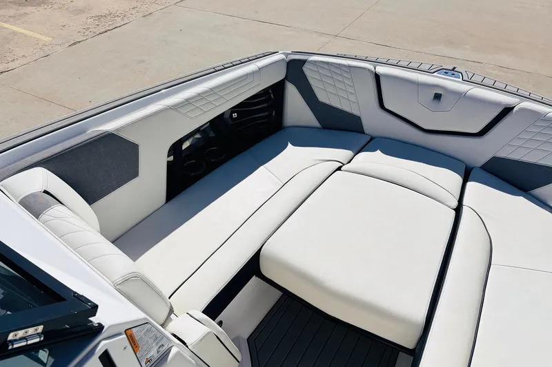 Slide: The Image of 2023 Nautique Super Air Nautique G25 boat interior with luxurious seating and modern design. - 12