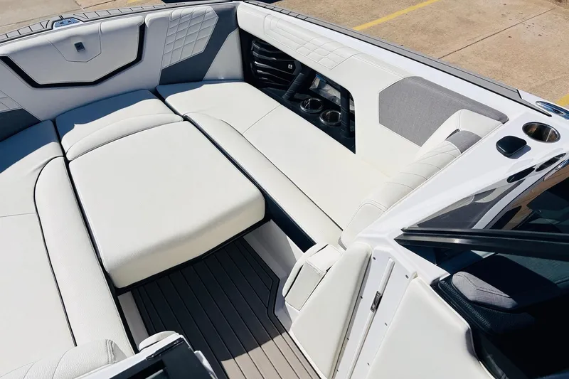 Slide: The Image of 2023 Nautique Super Air Nautique G25 interior with luxurious white seating and cup holders. - 13