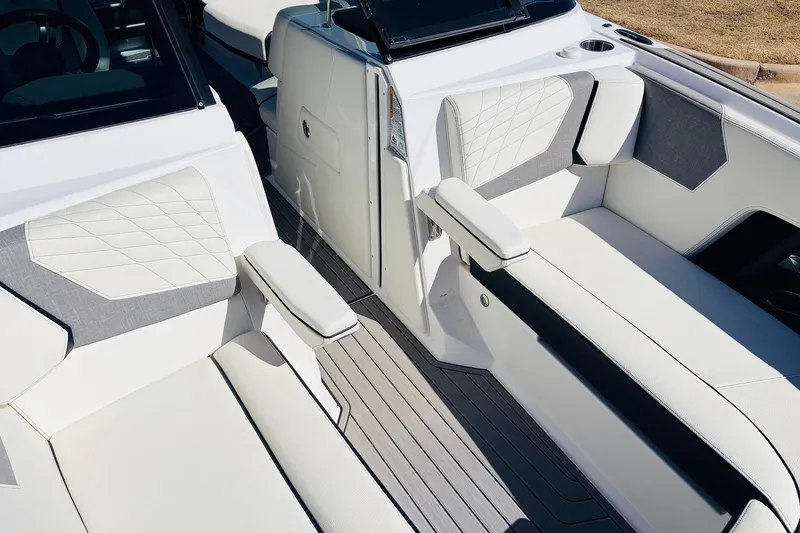 Slide: The Image of 2023 Nautique Super Air Nautique G25 interior with luxurious white and gray seating. - 17