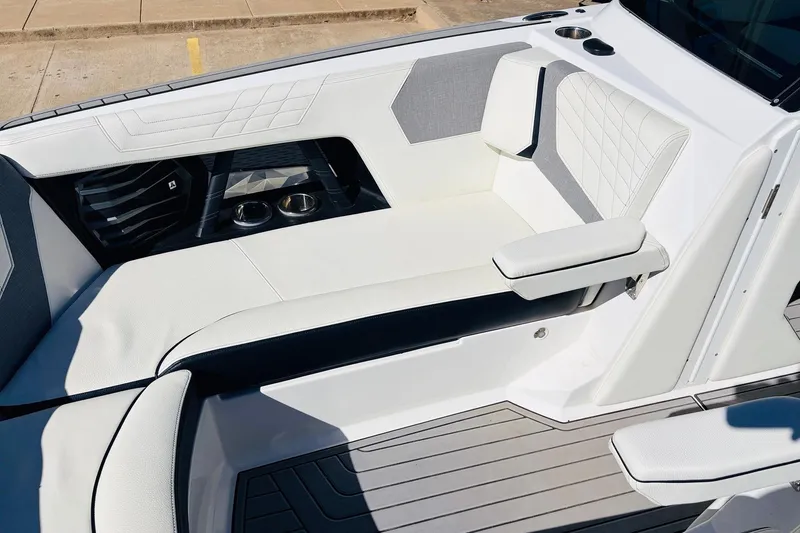 Slide: The Image of 2023 Nautique Super Air Nautique G25 interior with white seating and cup holders. - 18